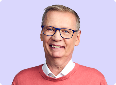 Günther Jauch steht lächelnd im Vordergrund mit verschränkten Armen. Dahinter steht Christian Ulmen der ein Rezept und ein Handy in der Hand hält.