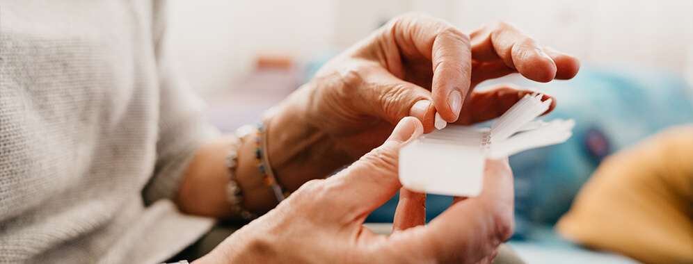 Eine Frau bestückt ihre Tablettenbox.