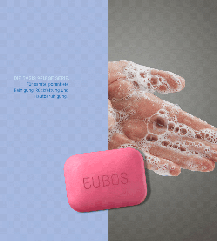Rosa Fest Waschstück und Hände in Seifenschaum. Text: DIE BASIS PFLEGE SERIE. EUBOS-Logo.