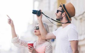 Paar mit Kamera, zeigt auf etwas.