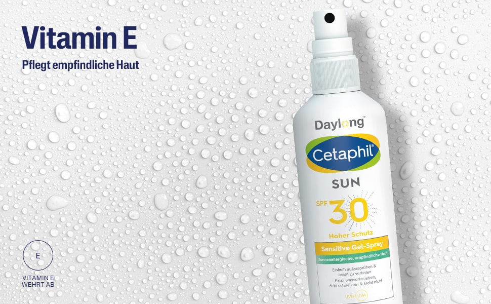 Text: Vitamin E pflegt empfindliche Haut. Tropfen auf weißem Hintergrund.