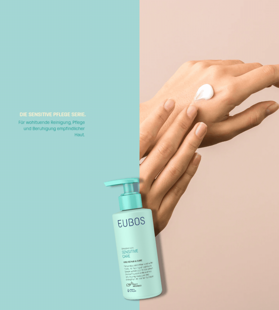 Hände mit Creme. EUBOS Sensitive Pflege Hand Repair & Schutz. Flasche im Hintergrund.