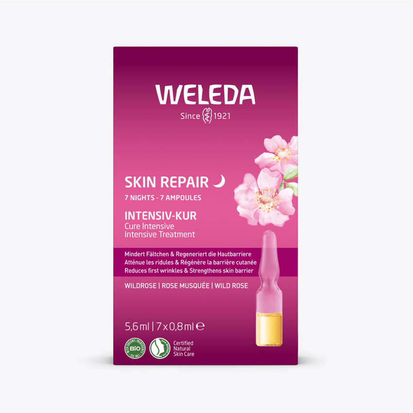 Verpackung Weleda Skin Repair Intensiv-Kur Wildrose. Rosa Verpackung mit Produktnamen und Blüten.