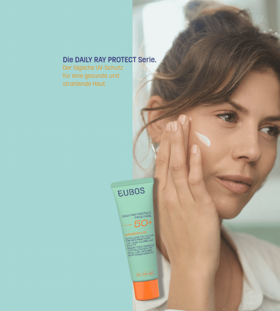 Frau mit Text: EUBOS, Daily Ray Protect Serie. Anwendung des Sonnenfluids.