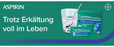 Verpackung mit Glas. Text: Aspirin Trotz Erkältung voll im Leben.
